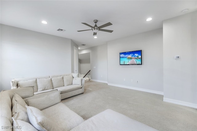 living room featuring light colored carpet and ceiling fan