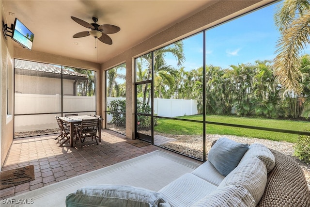 sunroom with a ceiling fan