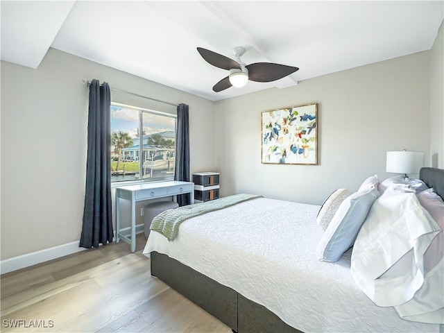 bedroom with light hardwood / wood-style flooring and ceiling fan