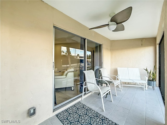 exterior space featuring ceiling fan