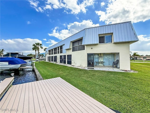 dock area featuring a water view and a yard