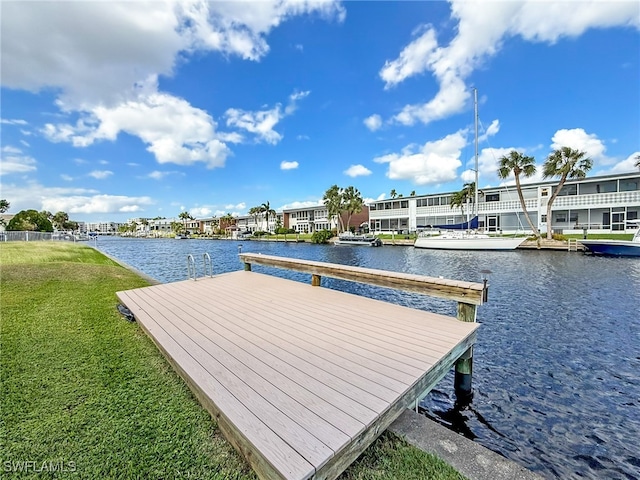 view of dock featuring a water view and a yard