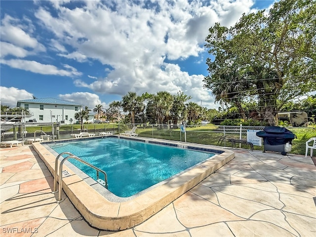 view of swimming pool with a patio area