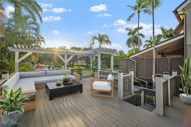 deck featuring ceiling fan, a pergola, and an outdoor living space