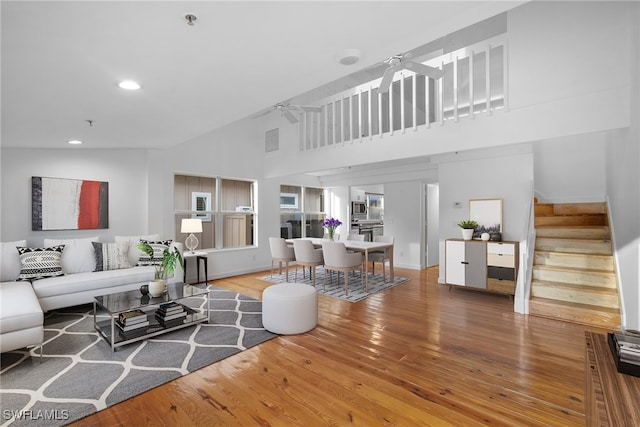 living room featuring high vaulted ceiling, hardwood / wood-style floors, and ceiling fan