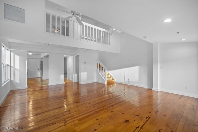 unfurnished living room featuring hardwood / wood-style floors and ceiling fan