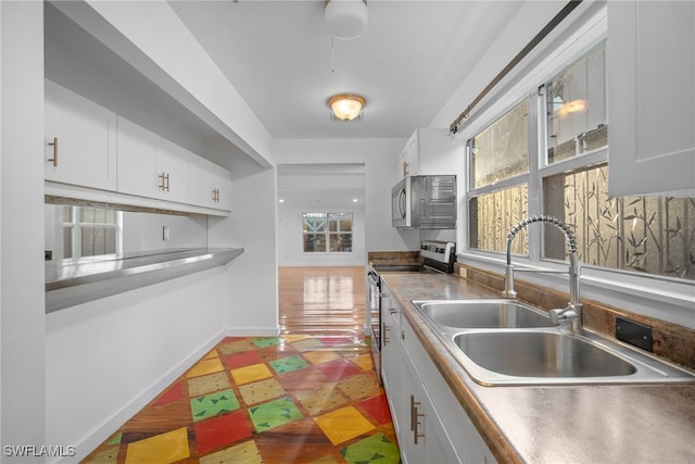 kitchen featuring white cabinets, a wealth of natural light, and stainless steel appliances