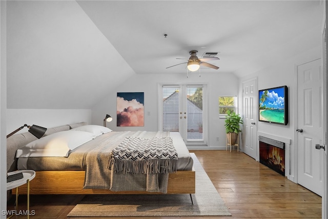 bedroom featuring wood-type flooring, vaulted ceiling, ceiling fan, and access to exterior