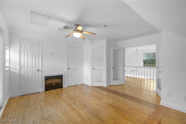 unfurnished living room featuring ceiling fan and light hardwood / wood-style flooring