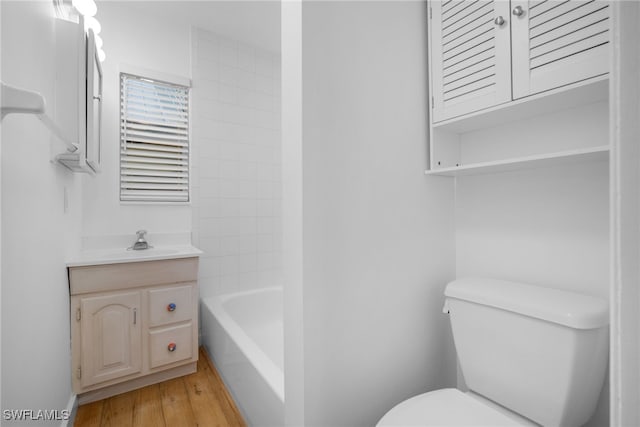 bathroom featuring wood-type flooring, vanity, and toilet