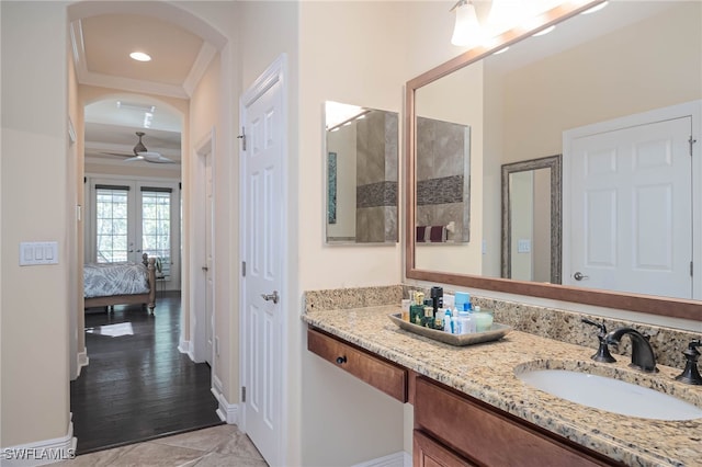 bathroom with wood-type flooring, vanity, french doors, and ornamental molding