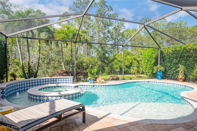 view of swimming pool featuring a lanai, a patio area, and an in ground hot tub