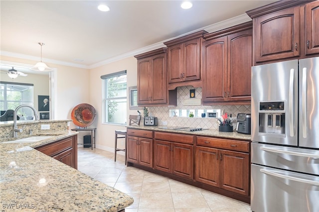 kitchen featuring sink, stainless steel refrigerator with ice dispenser, backsplash, crown molding, and pendant lighting