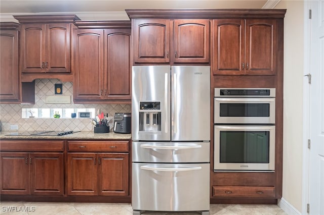 kitchen featuring backsplash, light tile patterned flooring, light stone counters, and stainless steel appliances