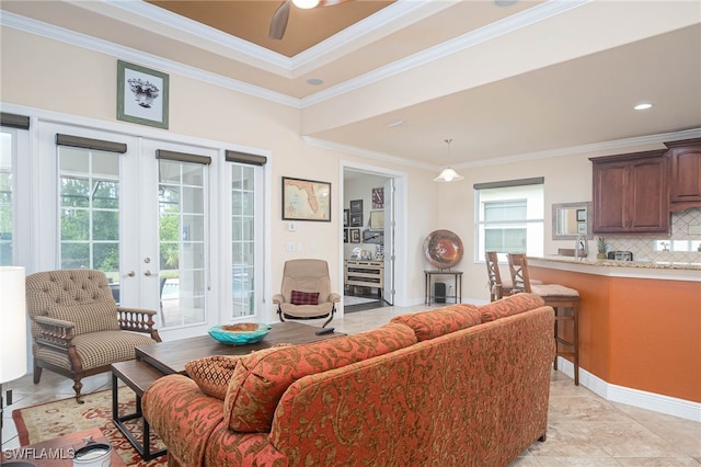 tiled living room with ceiling fan, ornamental molding, and french doors