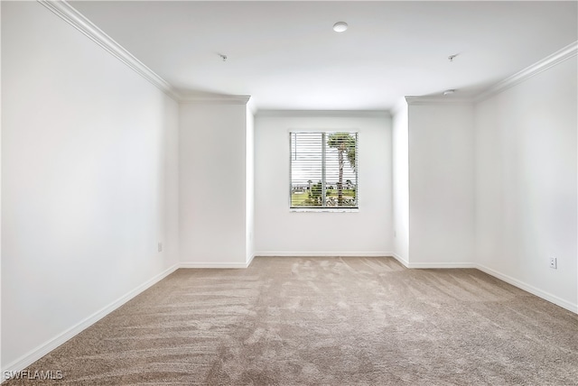 unfurnished room with light colored carpet and ornamental molding