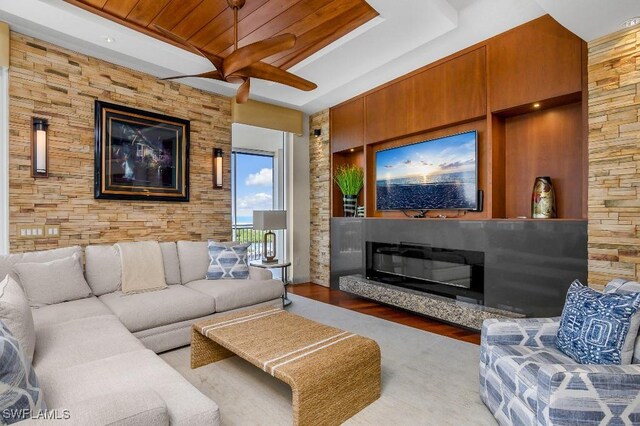 living room with hardwood / wood-style floors, ceiling fan, and wood ceiling