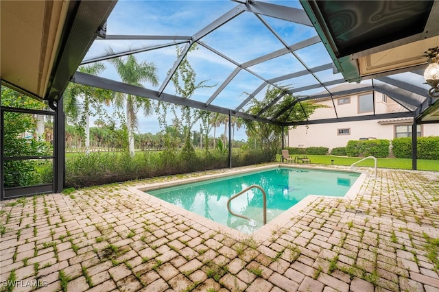 view of swimming pool featuring a patio area and a lanai