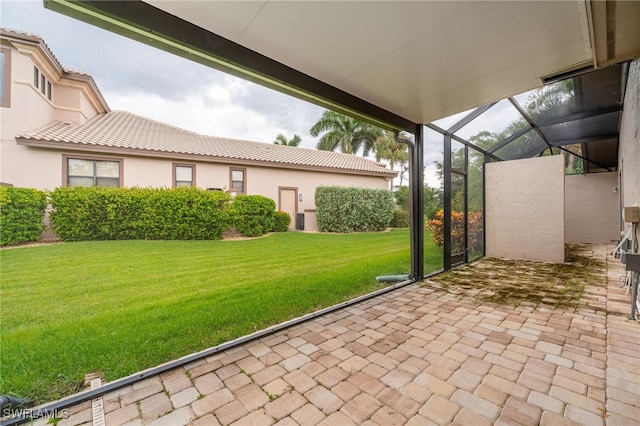 view of patio with glass enclosure