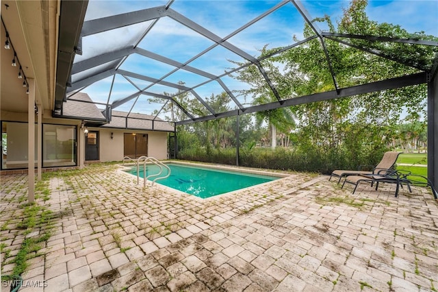 view of pool with a lanai and a patio area