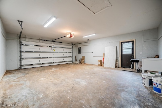 garage featuring electric panel and a garage door opener