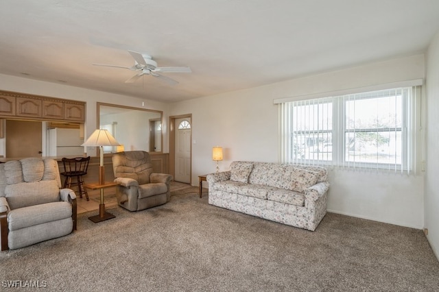 carpeted living room with ceiling fan