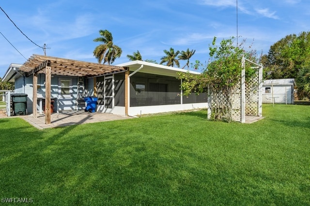 rear view of property featuring a yard, a pergola, a patio, and a sunroom