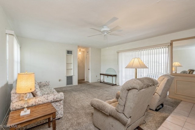 tiled living room with ceiling fan