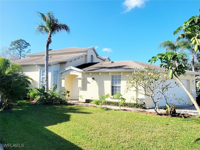 view of front of home with a front lawn and a garage