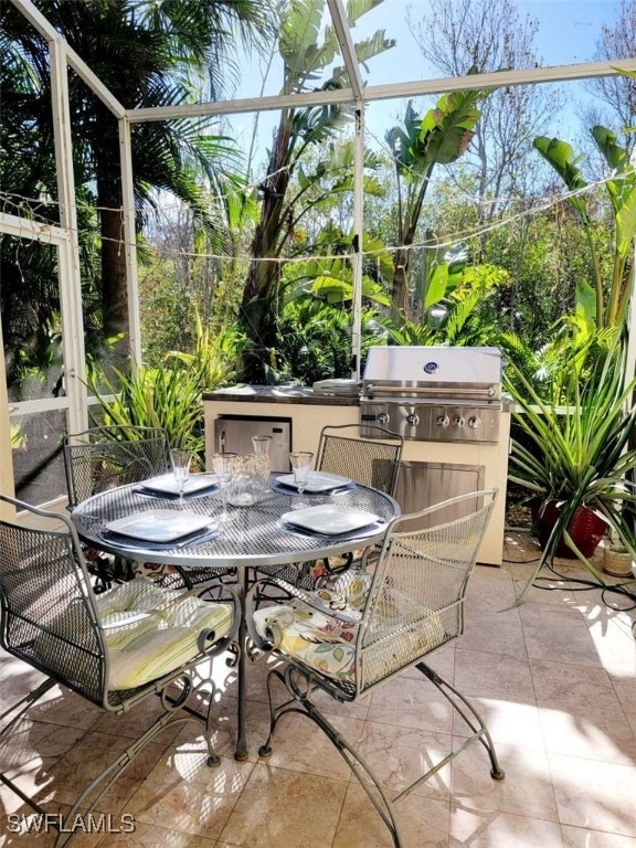 view of patio / terrace featuring glass enclosure and grilling area