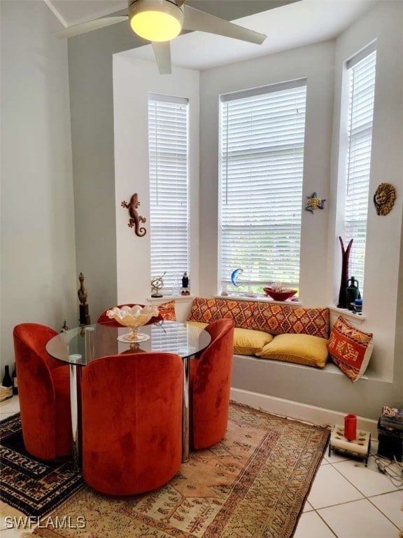 dining room featuring ceiling fan, light tile patterned floors, and a healthy amount of sunlight