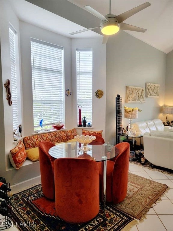 dining space with light tile patterned floors, plenty of natural light, lofted ceiling, and ceiling fan