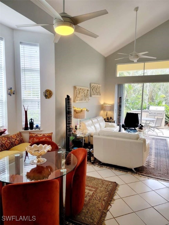 tiled living room with high vaulted ceiling and ceiling fan