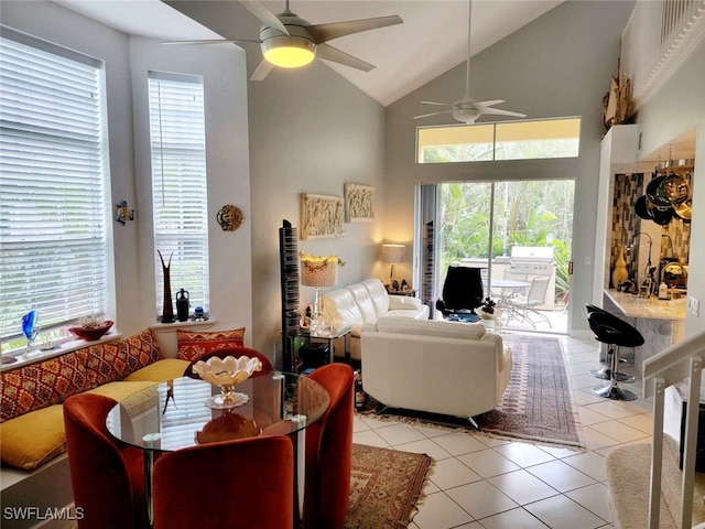 living room featuring light tile patterned floors, high vaulted ceiling, and ceiling fan