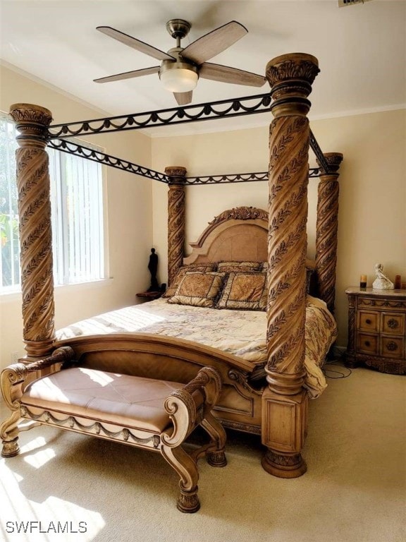 bedroom with carpet, ceiling fan, and crown molding