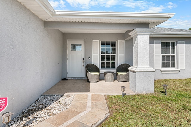 doorway to property featuring a yard