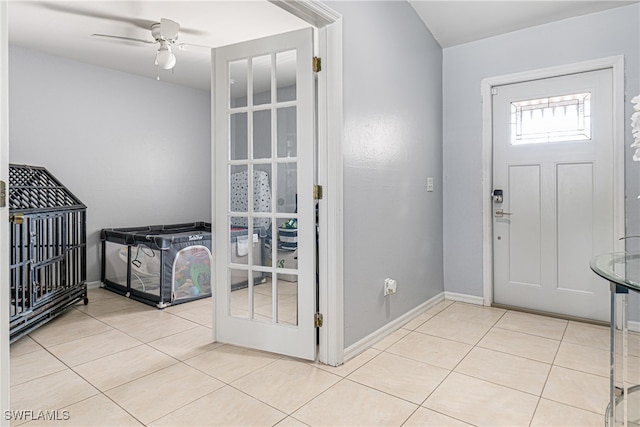 entryway with ceiling fan and light tile patterned flooring