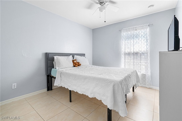 bedroom featuring light tile patterned floors and ceiling fan