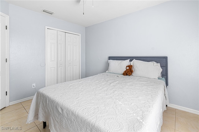 tiled bedroom with a closet