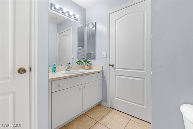 bathroom with tile patterned flooring and vanity