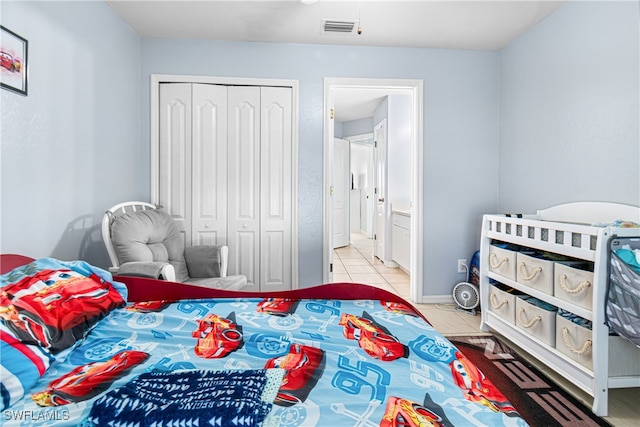 bedroom with light tile patterned flooring and a closet