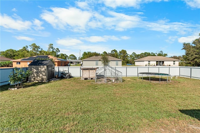 view of yard with a trampoline and a storage unit