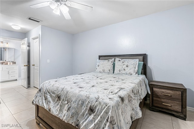 bedroom featuring ensuite bath, ceiling fan, and light tile patterned flooring