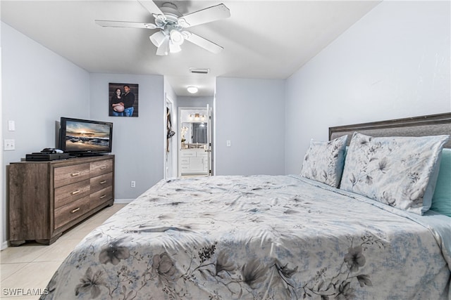 tiled bedroom with connected bathroom and ceiling fan