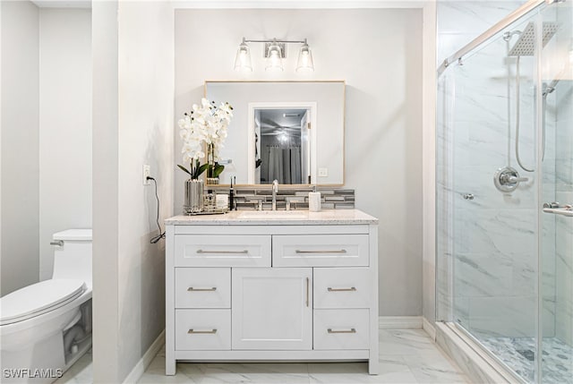 bathroom featuring vanity, toilet, and an enclosed shower