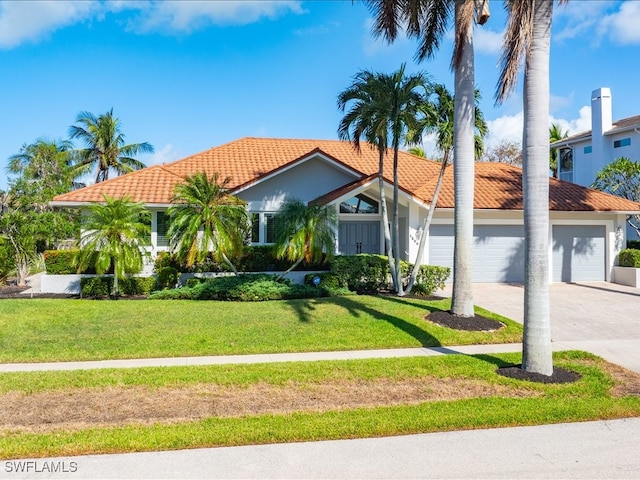 mediterranean / spanish-style house with a front lawn and a garage