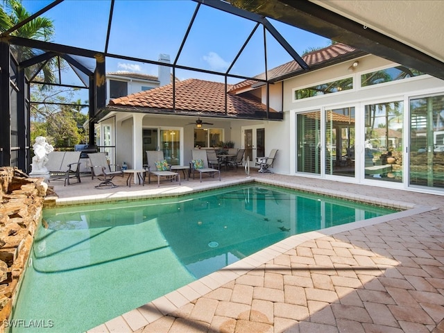 view of pool featuring a patio area, a lanai, and ceiling fan