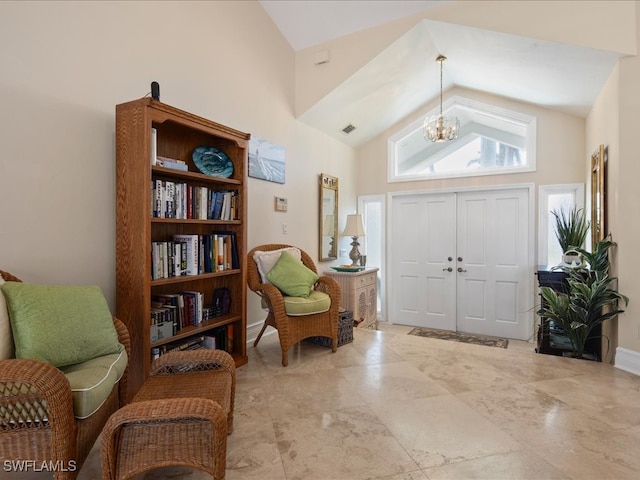 entrance foyer with high vaulted ceiling and an inviting chandelier