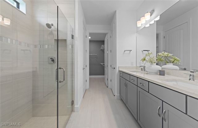 bathroom with tile patterned flooring, an enclosed shower, and vanity