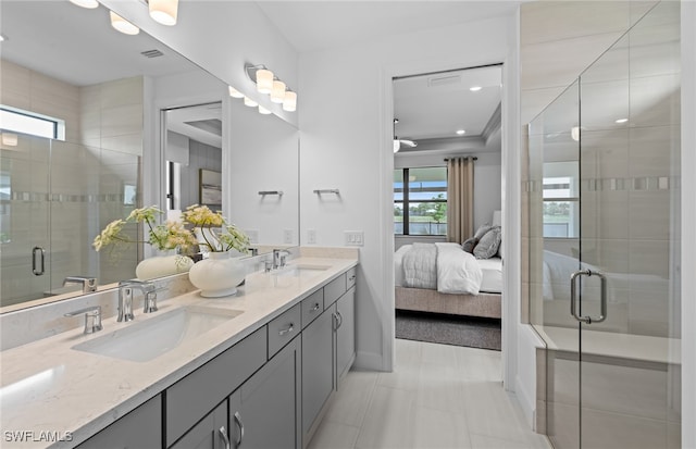 bathroom with vanity and a shower with shower door